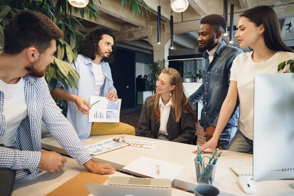 Un groupe diversifié de professionnels discutant autour d'une table de conférence dans un cadre moderne, représentant les services de consulting et organisation SI .